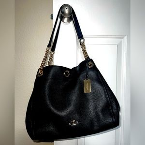 Black leather Coach shoulder bag with gold chain accents. Excellent condition!